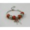 Silbernes Armband mit orangefarbenen Perlen und Schleife