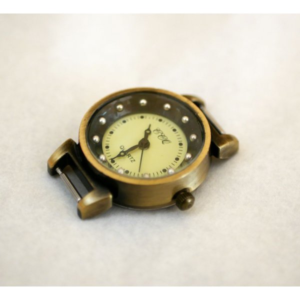 Zifferblatt bronzefarbene und schwarze Uhr mit Federn