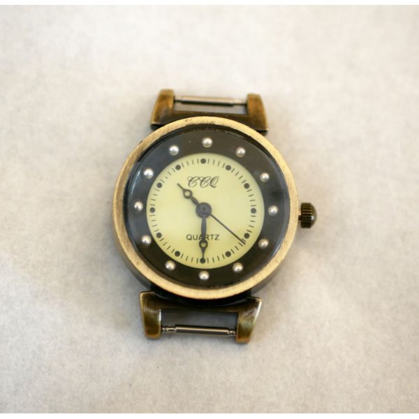 Zifferblatt bronzefarbene und schwarze Uhr mit Federn